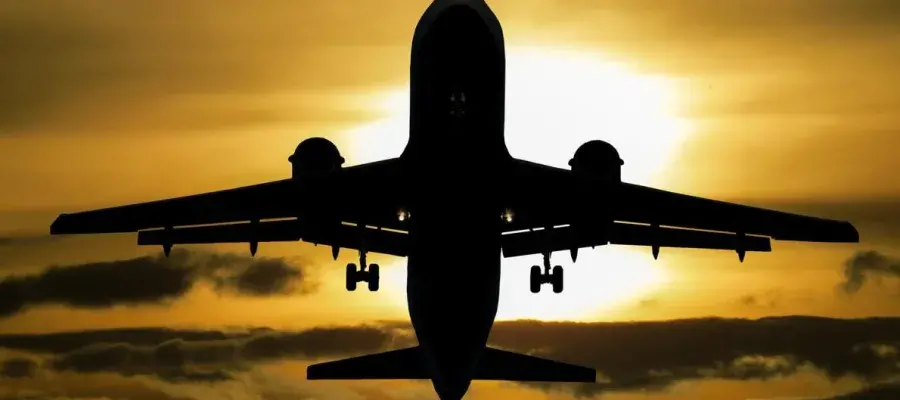 sillouette of an airplane against a sunset