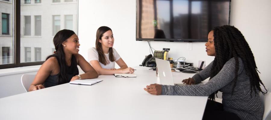 Three women sitting at a table and talking