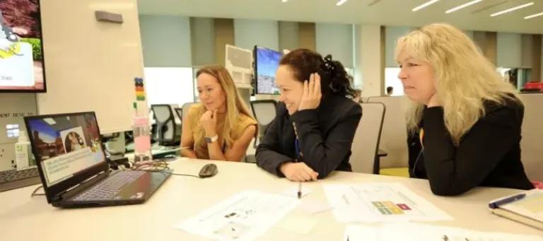 Image of three people working together